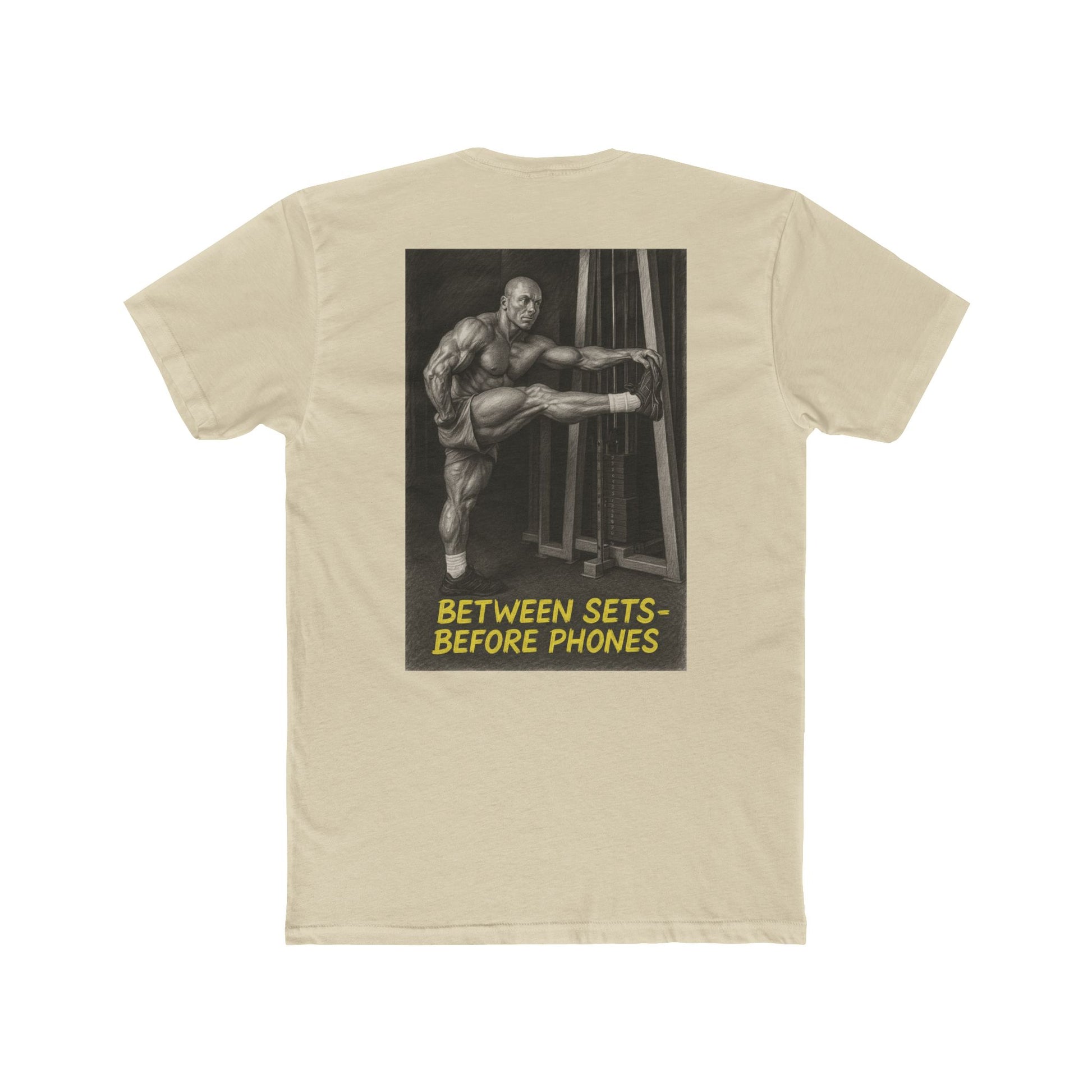 Beige t-shirt with graphic of a muscular man and text 'Between Sets Before Phones' on a white background