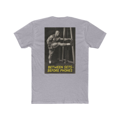 Gray t-shirt with a graphic of a muscular man and text on the back, on a white background