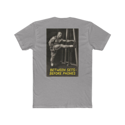 Gray t-shirt with a graphic of a muscular man and text on the back, on a white background