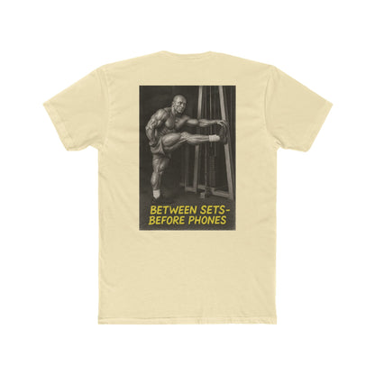 Beige t-shirt with a graphic of a muscular man and text on the back, on a white background